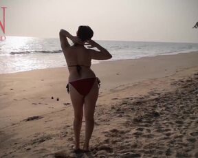 Nice lady at lonely nudist beach. Red swimsuit. Red bikini.