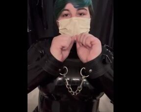 Girl cuffs her self in a latex catsuit