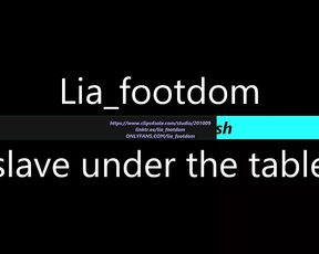 Foot slave lies under the table